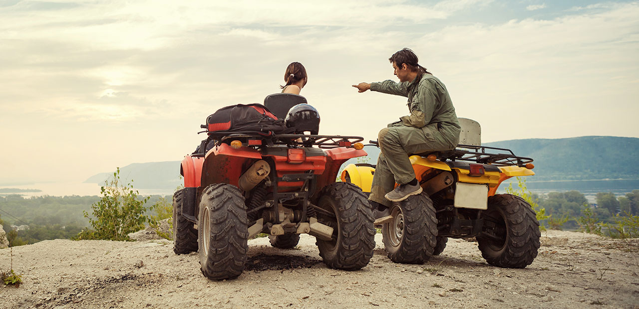 Man and woman on ATVs